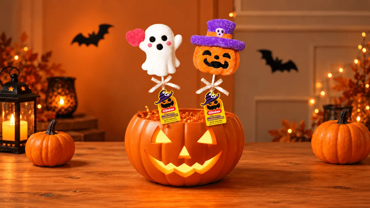 Ghost and pumpkin Halloween treats displayed in a glowing jack-o’-lantern